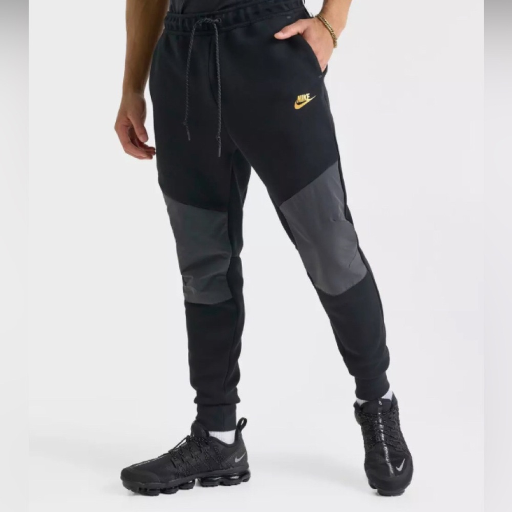 Nike Black Joggers with Gray Knee Panels and Gold Swoosh